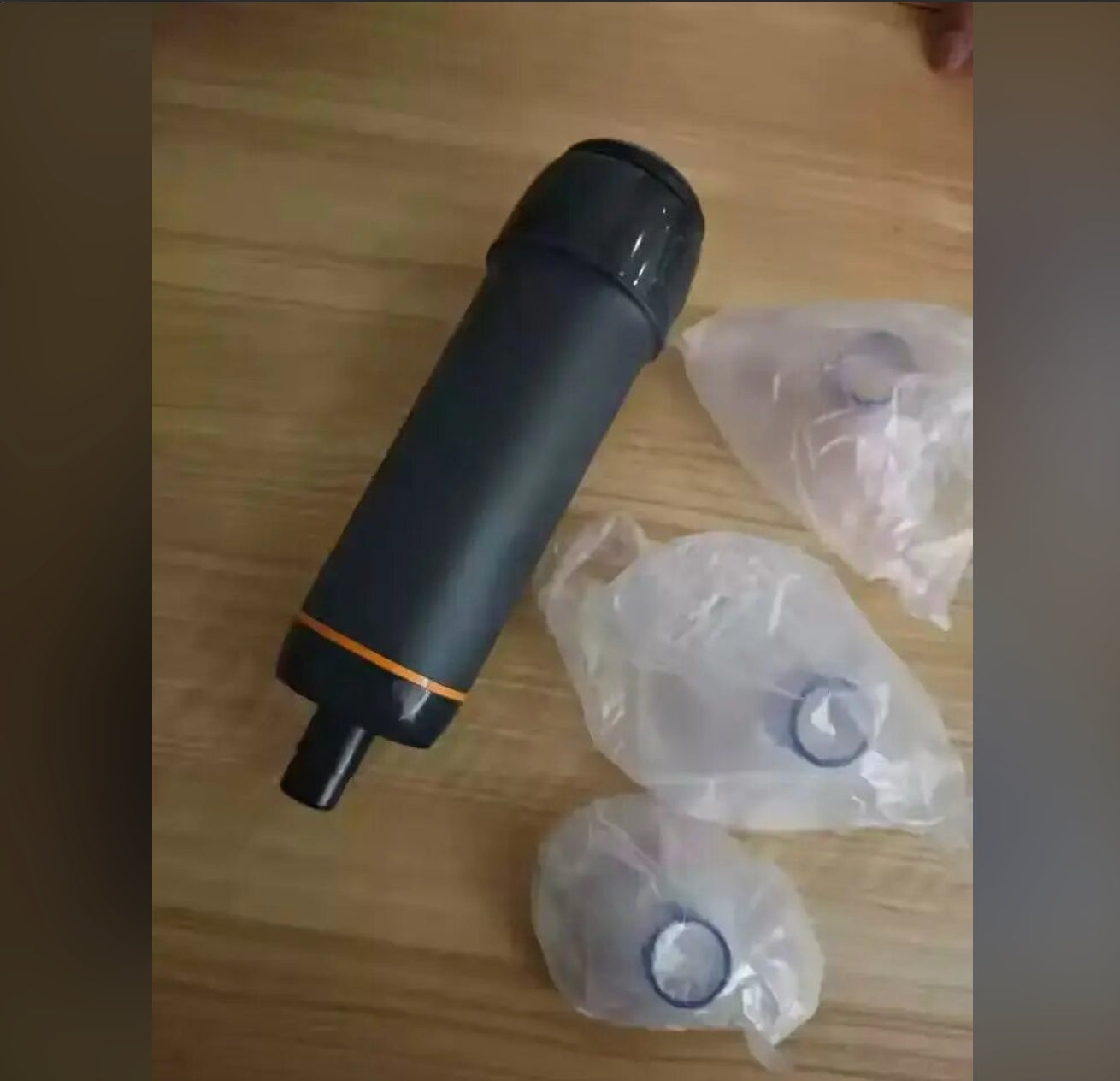 The charcoal suction device and separately wrapped masks on a wooden table.