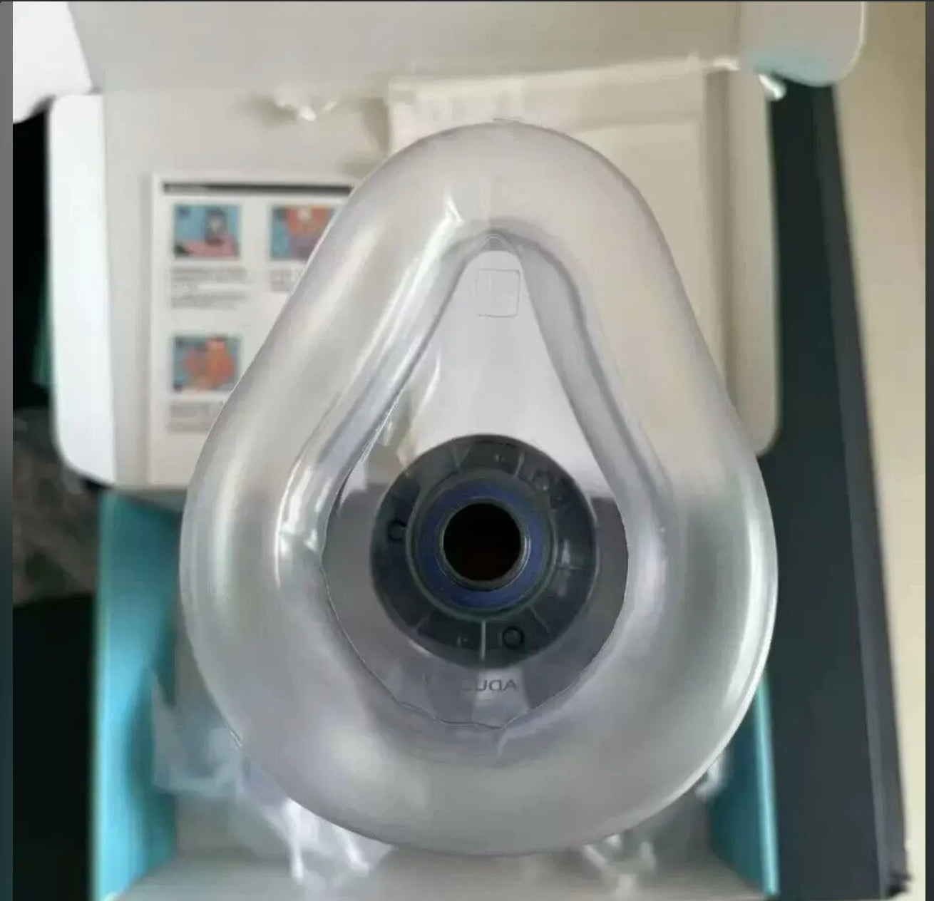 A front view of the clear mask and its dark connector.